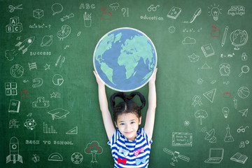 Educated school kid lifting world globe chalk doodle drawing on green chalkboard for education...