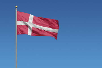 Flag of Denmark in front of a clear blue sky