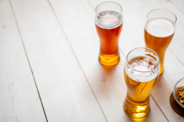 glasses of assorted beer on a wooden table background with copy space for text