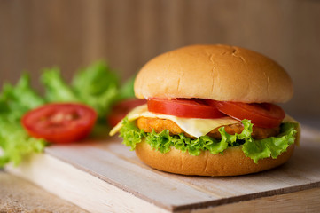 fish burger with cheese, Lettuce and tomatoes.