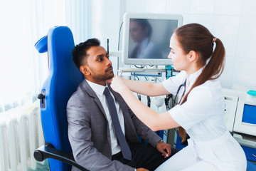 Obraz premium medical checkup. A beautiful female doctor holds the Asian patient's hand for encouragement and sympathy and touching her hand. concept of partnership, trust and medical ethics. Bad news and support.