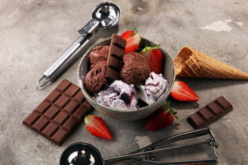Chocolate coffee ice cream ball in a bowl and strawberry and vanilla