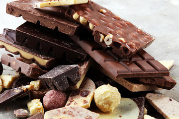 Chocolate bars on table with chocolate tower.