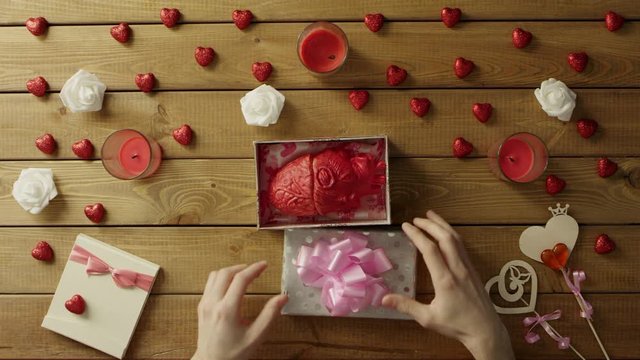 Man gets plastic human heart as strange holiday present from a stranger, top view