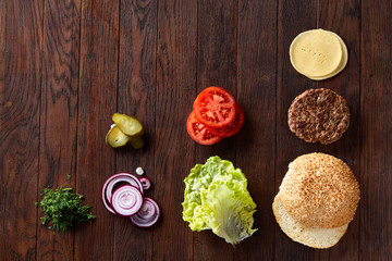 Tasty hamburger ingredients are laid out separately from above, beautifully harmoniously, close-up, top view
