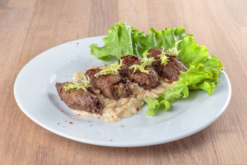 twists of beef with side dishes, pine nuts and lettuce