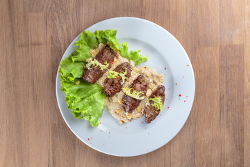 twists of beef with side dishes, pine nuts and lettuce