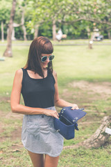 Fashionable woman with luxury snakeskin python handbag outside. Snakeskin fashion concept.