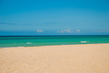 Tourists relax on Varadero sandy beach.Paradise landscape with turquoise sea and white sand. Cuba