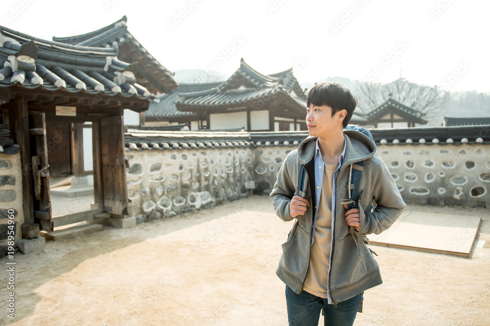 Wall mural young man traveling in korea