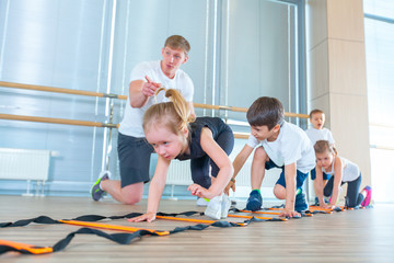 Happy sporty children in gym. Kids exercises
