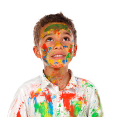 Funny boy with hands and face full of paint