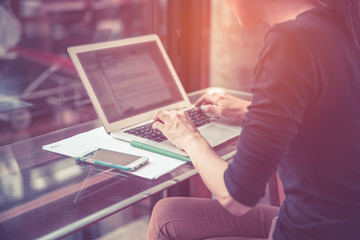 Close up portrait of a young asian woman looking at laptop