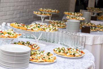 holiday buffet table served by different canape, sandwiches, snacks ready for eating in restaurant