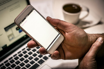 Holding white screen smart phone.