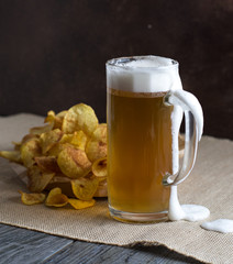 beer,beer on the brown background,beer and chips on a brown background, beer on a light background, beer on a dark background, beer and chips on a dark background,beer and chips on a light background