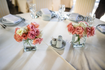 A table with beautiful flowers eustoma in a cafe - restaurant on a hotel