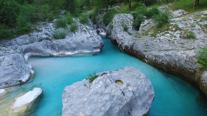 AERIAL view: flight over mountain river Soca. Camera flying backwards