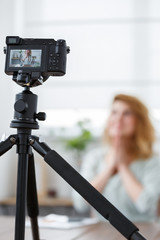Defocused picture of blonde florist at table with florarium.