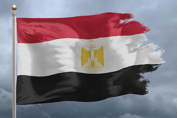 Egypt Flag with torn edges in front of a stormy sky