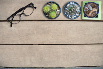 Mock up glasses and cactus on wooden table, top view