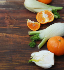 Fennel Vegetable Isolated. Fennel and Orange Citrus Fruit over Wooden Background. Healthy Vegetarian Food.