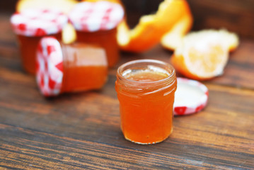 Orange Jam in Glass Jar on Wooden Background. Fruit Jam with Citrus Fruits. Rustic Homemade Sweet Jam.