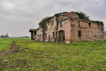 Fototapeta na wymiar Ruined old countryside house. Abandoned house feels bad