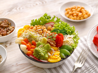 Buddha bowl, healthy and balanced vegan meal, fresh salad with a variety of vegetables, healthy eating concept. Top view
