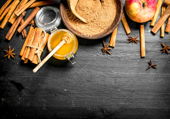 Fresh honey with ground cinnamon and an Apple.