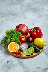 Fototapeta na wymiar Still life of fresh organic vegetables on wooden plate over white background, selective focus, close-up