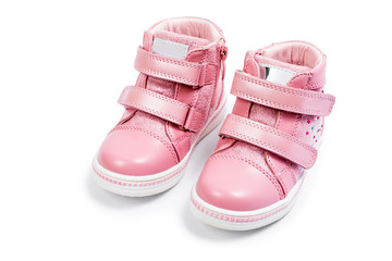Fototapeta na wymiar the pink children's sneakers isolated on a white background
