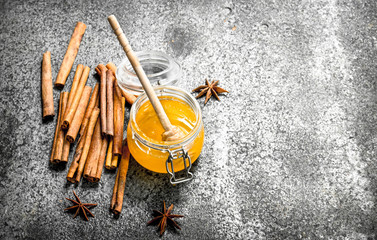 Fresh honey with cinnamon sticks.
