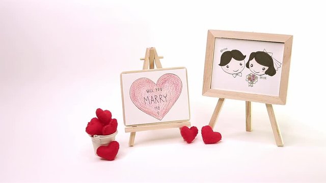 Lovely Groom and Bride and Big Heart write ' Will You Marry Me ? ' Drawing by Color Pencil on Wooden Frame with Red Heart Fabric in White Bucket  