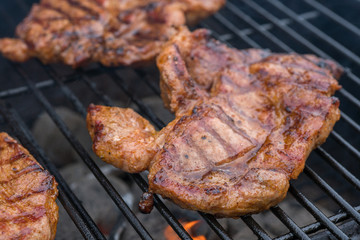 pork steak meat on bbq grill
