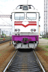 Naklejka premium Electric locomotive of white color stands on rails