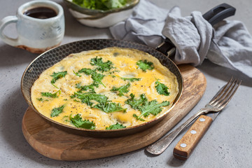 Omelette with baby kale leaves