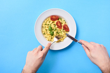 Scrambled eggs in plate on rustic background
