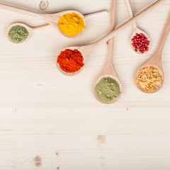 spices and herbs on kitchen wooden table background with copy space for text. food, cooking and restaurant concept. flat lay colorful composition, top view