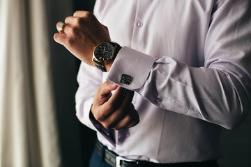 Businessman wears a watch. The ring on his finger. Success. Business.