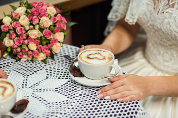 girl drinks coffee with chocolate candies at a cafe