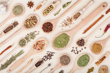 spices and herbs on kitchen wooden table background. food, cooking and restaurant concept. top view, flat lay