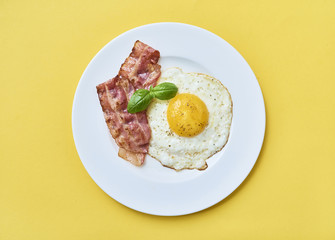 tastu fried egg in plate with bacon