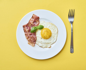 tastu fried egg in plate with bacon