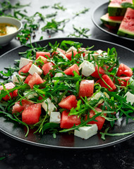Fresh Juicy Watermelon arugula Feta salad with mint and orange, lemon dressing. summer dish. healthy food