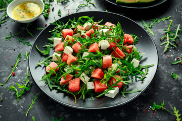 Fresh Juicy Watermelon arugula Feta salad with mint and orange, lemon dressing. summer dish. healthy food