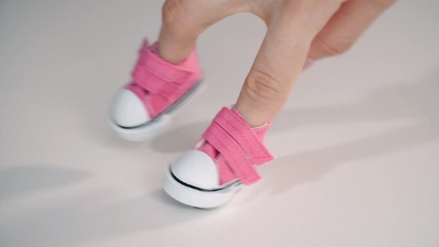 Hand fingers wearing in shoe