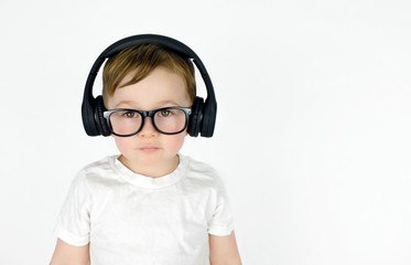 Cute little boy listening to music with headphones