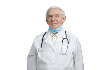 Portrait of senior doctor wearing stethoscope and mask. Smart frowning gloomy physician in white isolated background.
