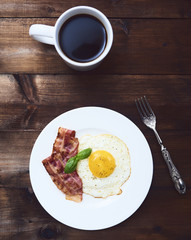 tastu fried egg in plate with bacon